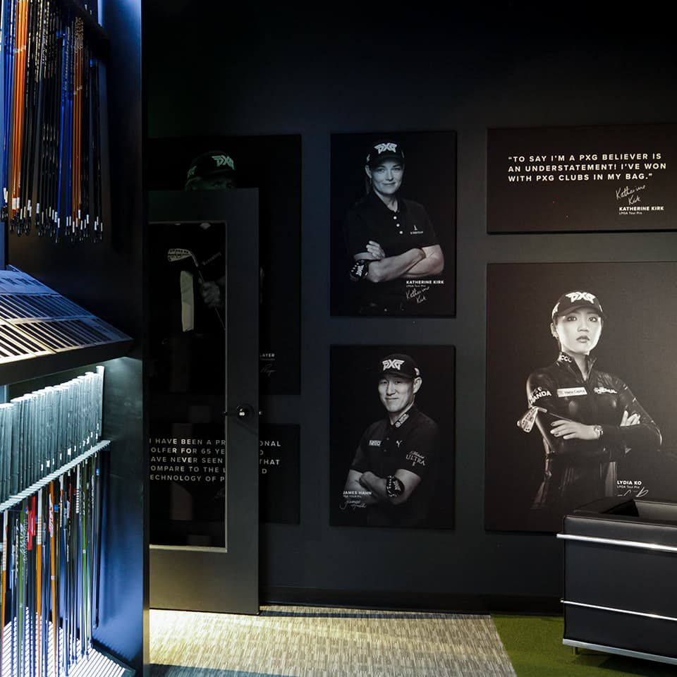 PXG Norterra Interior with photos of PXG Tour Pros and a wall of golf shafts.