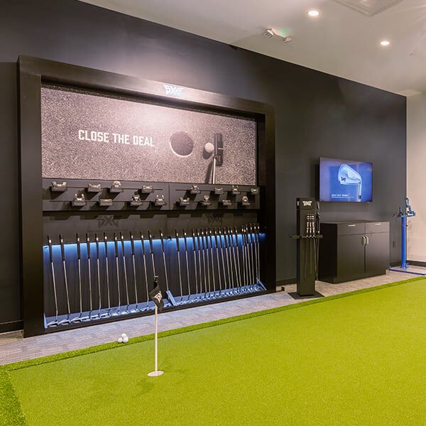 PXG Fairfax Interior with a fitting bay and a wall of golf shafts.