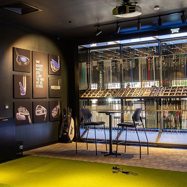 PXG Orlando Interior with a fitting bay and a wall of golf shafts.