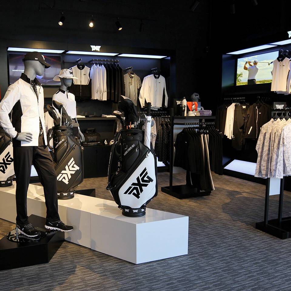 PXG Norterra Interior with photos of PXG Tour Pros and a wall of golf shafts.