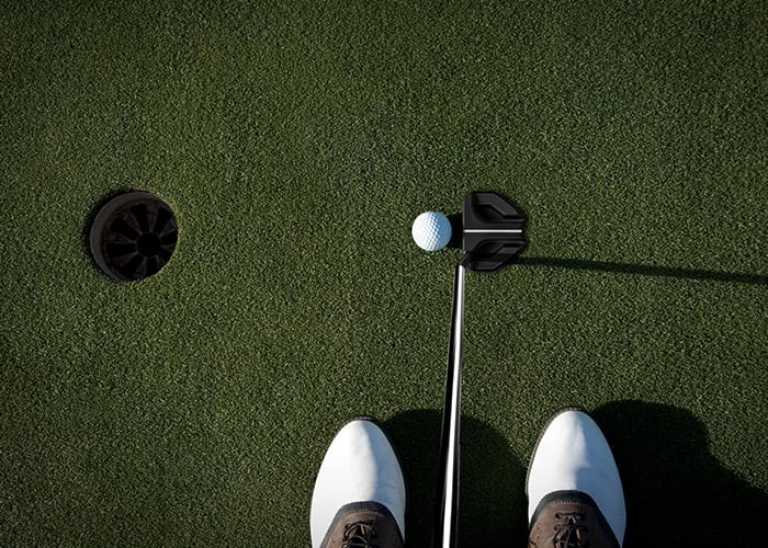 Female golfer putting